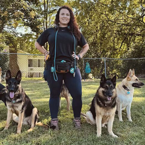 dog trainer and three dogs